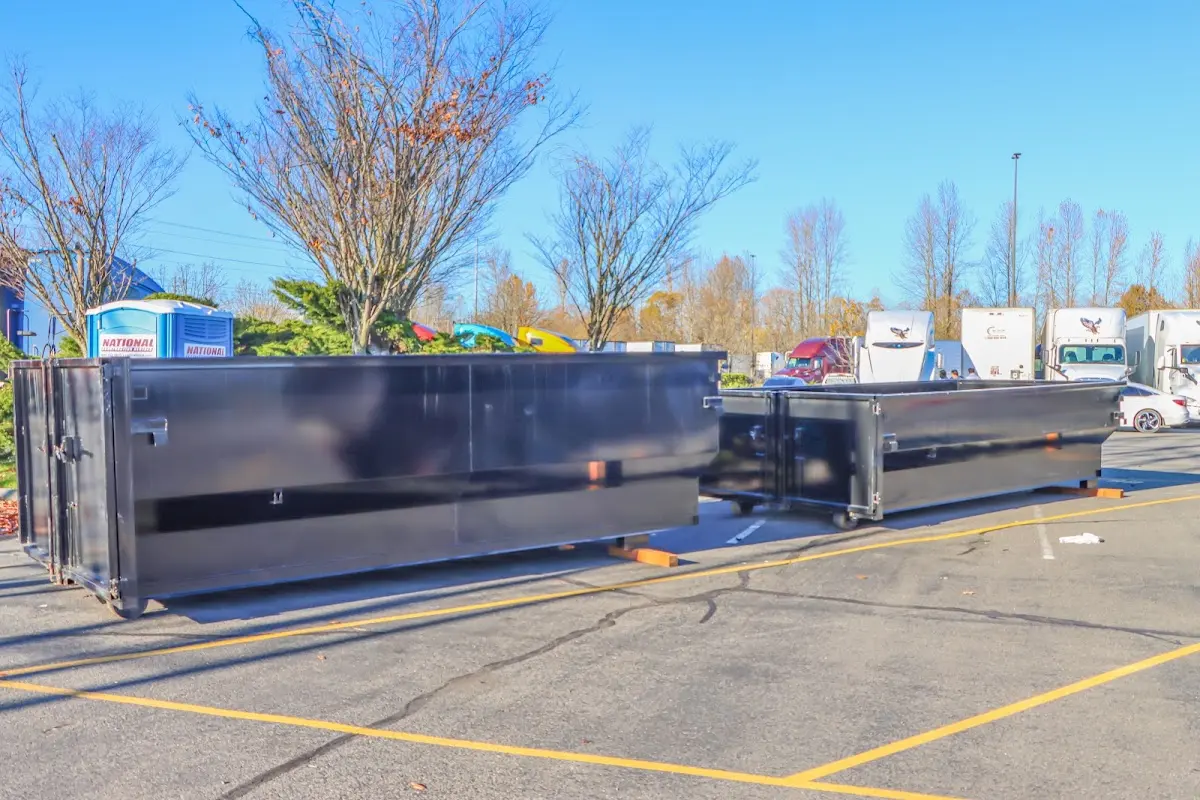 Professional dumpster rental service with roll-off container on residential driveway in Linden